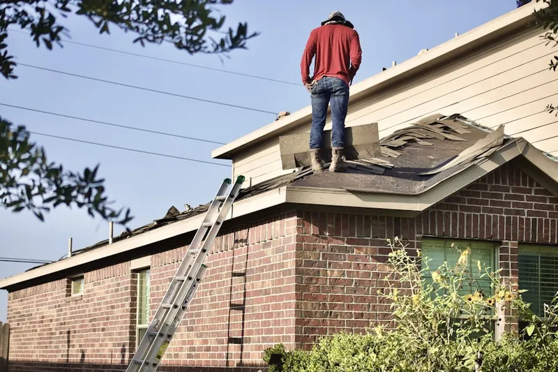 Professional roofer working on a residential roof in Visalia